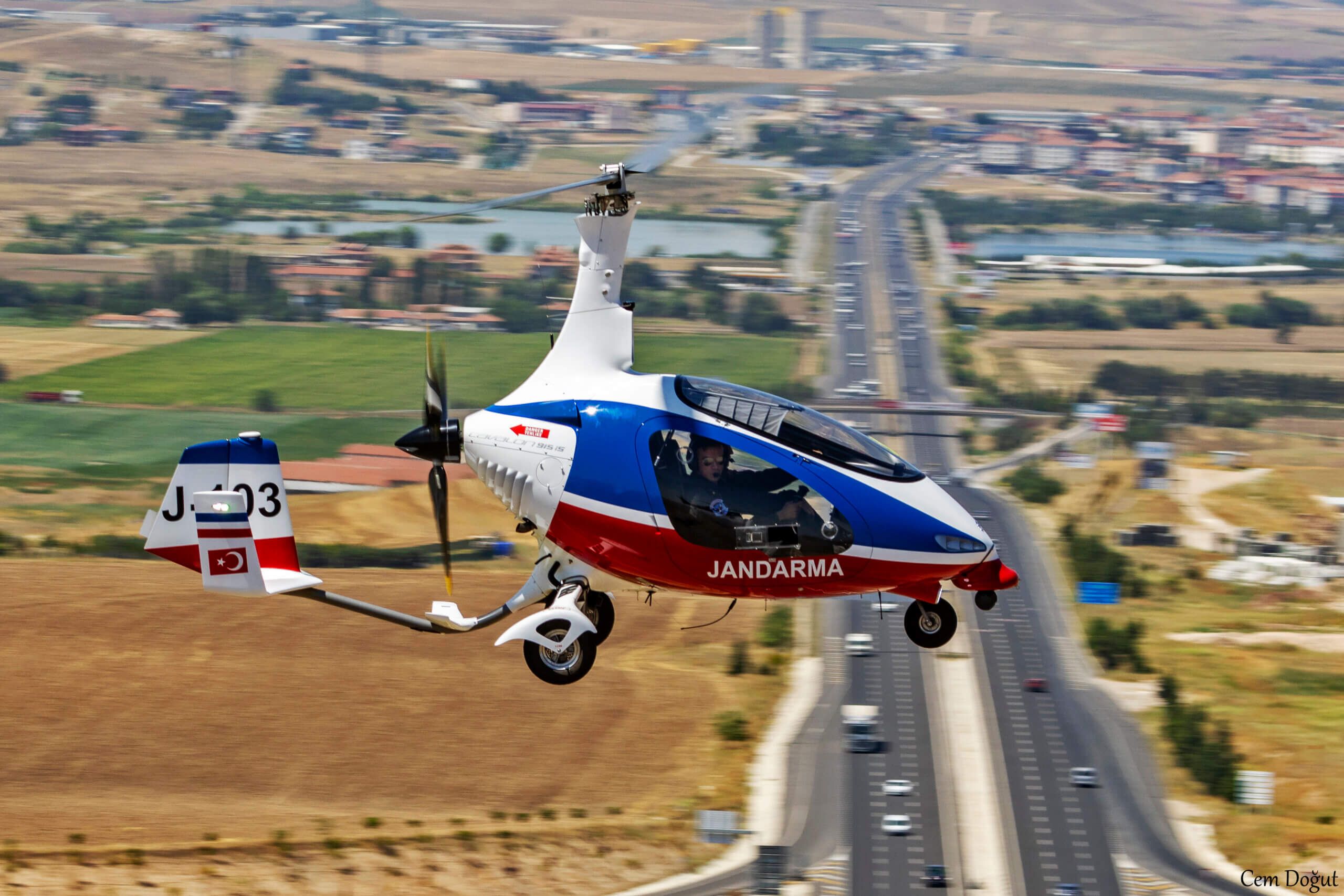 AutoGyro Sentinel Cavalon Flying along highway 