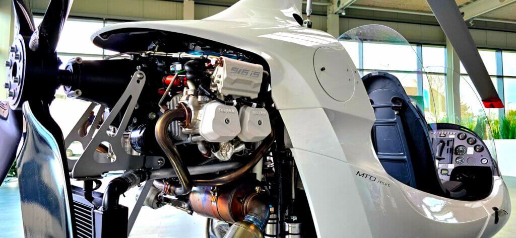 AutoGyro Close-up of a small aircrafts open engine compartment in a hangar, poised for a successful certifications achievement